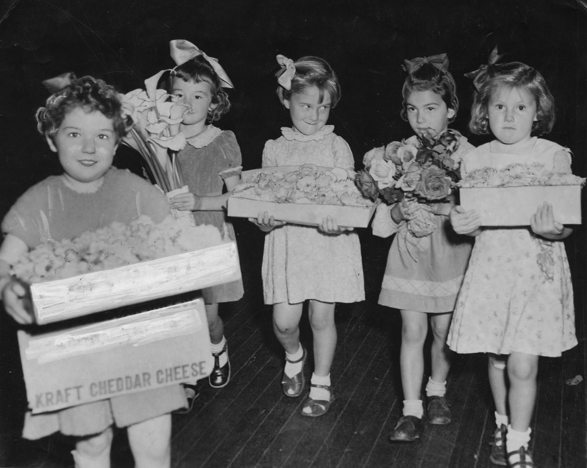Young girls carrying flower displays at the Chelsea Flower Show in Brisbane, 1952