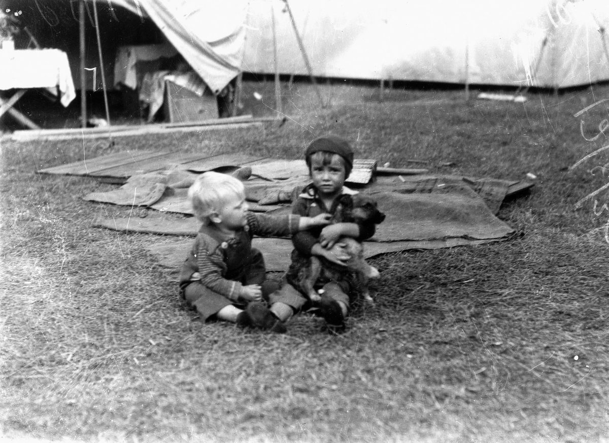 Children playing with a puppy at the Exhibition, 1938, Brisbane