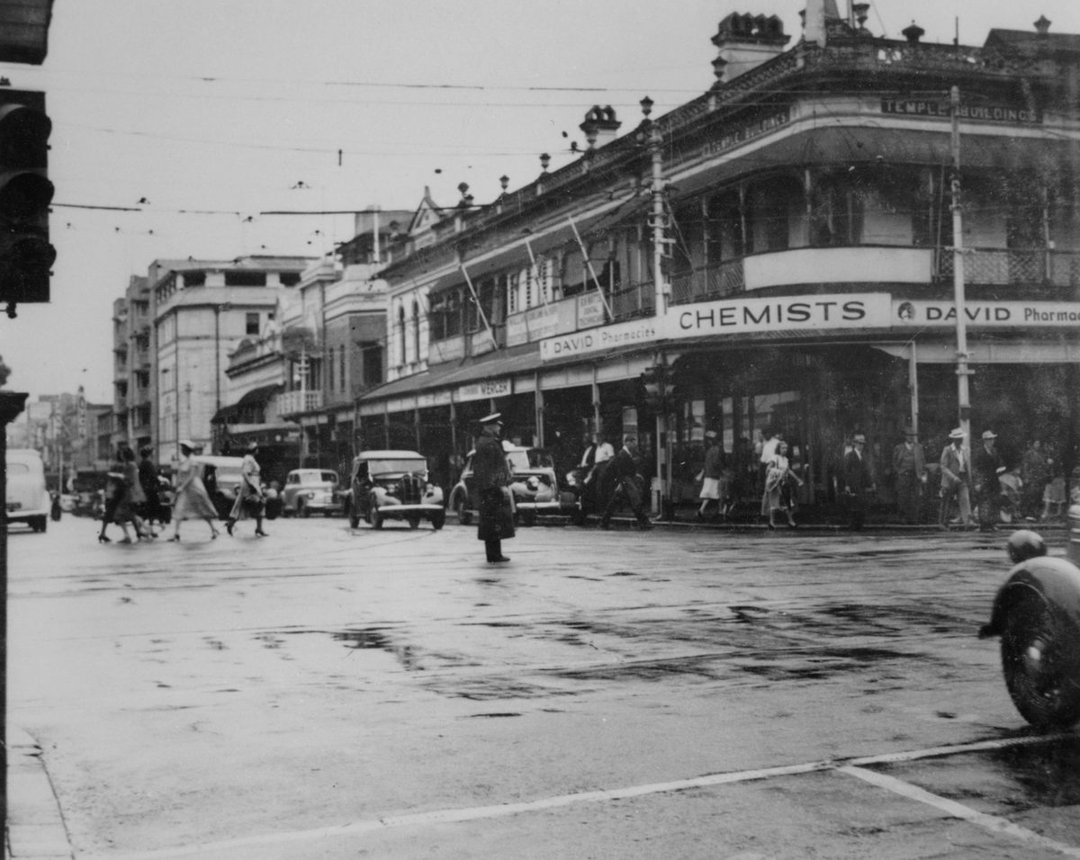 Police officer directing traffic on George Street, Brisbane, 1950, Brisbane City