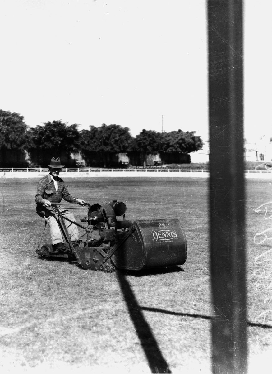 Man cutting grass at the Brisbane Exhibition, 1938, Bowen Hills