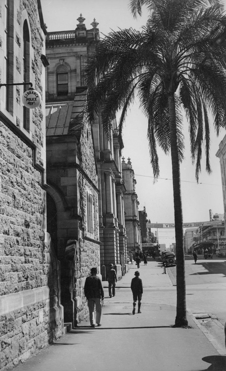 People walking along the footpath outside the police department on George Street, Brisbane, 1940, Brisbane City