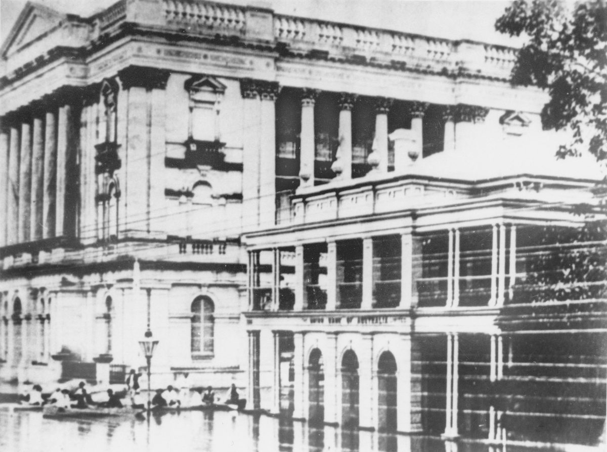 Boats rowing down the street in front of the Union Bank during the 1893 floods, Brisbane