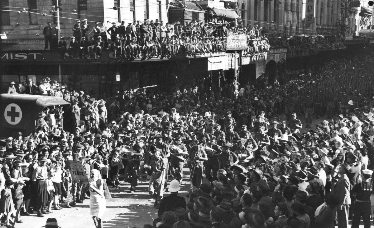 Army band leads a procession of soldiers on VJ Day in Brisbane, 1945