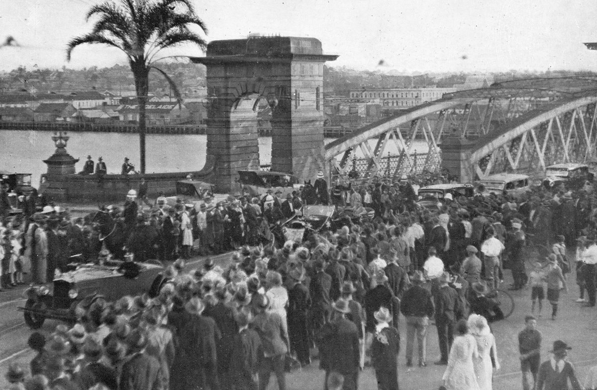 Pilot C. W. A. Scott waves to the crowd from a procession car at Victoria Bridge, Brisbane, 1931, Brisbane City