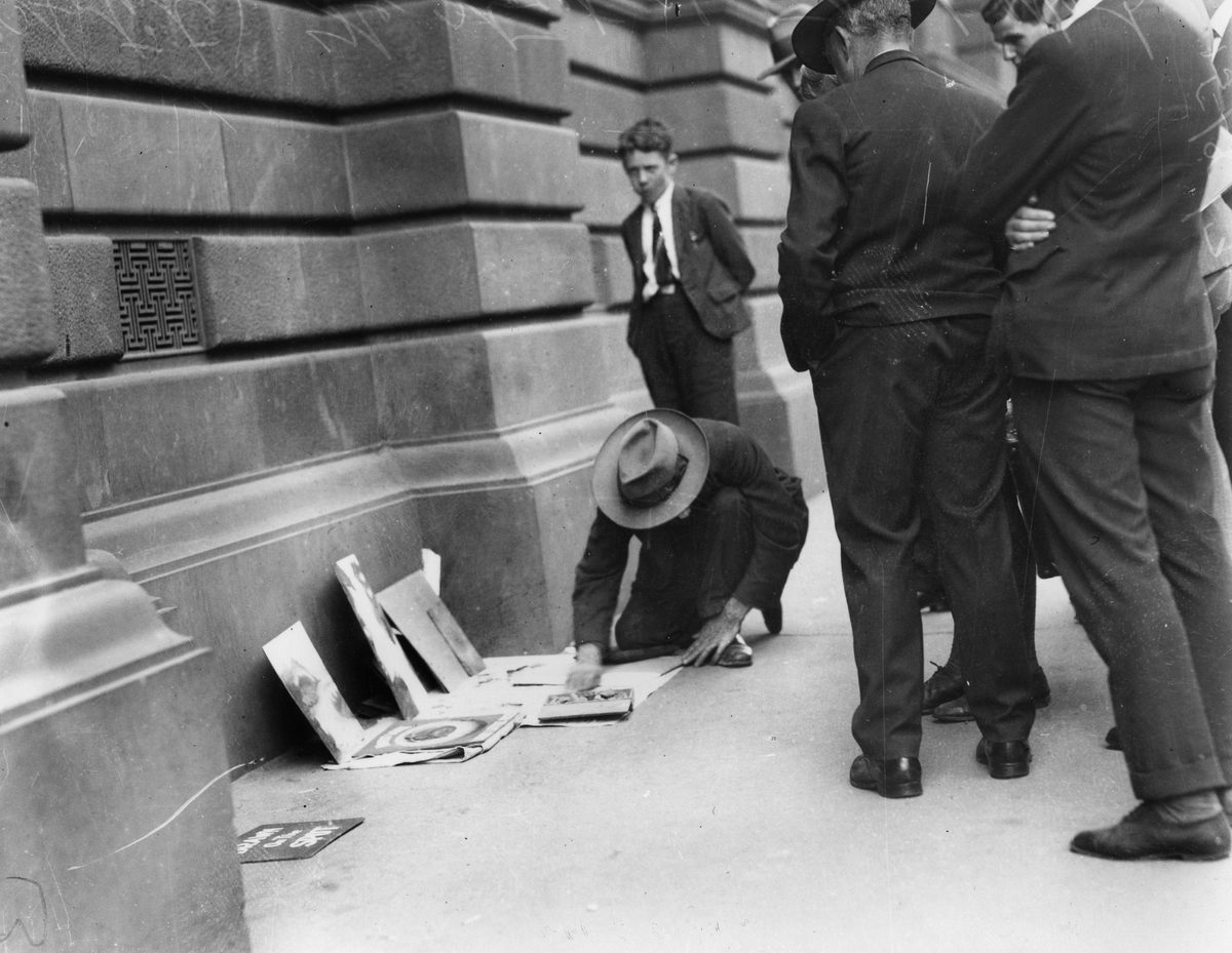 Pavement artist at work in front of a lunchtime audience, 1934, Brisbane
