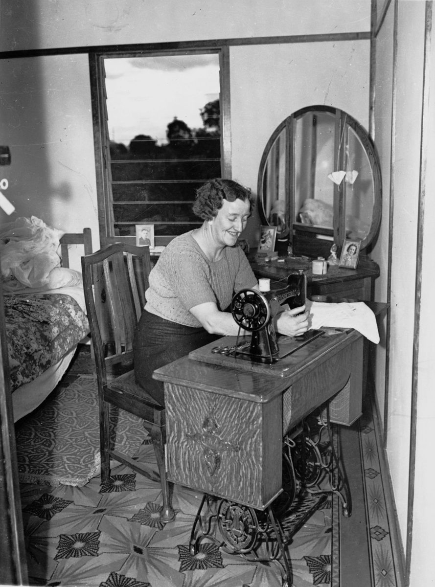 Woman seated at a Singer treadle sewing machine, Rocklea, 1944
